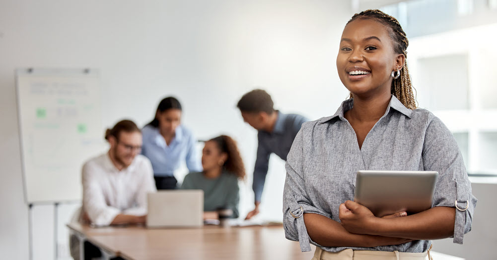 Young woman holding tablet.