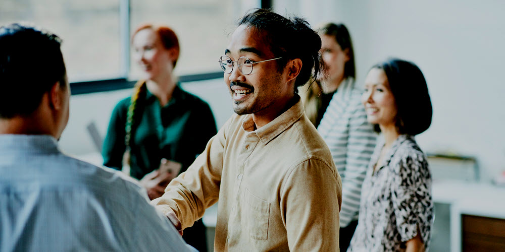 Young professional meeting his colleagues.