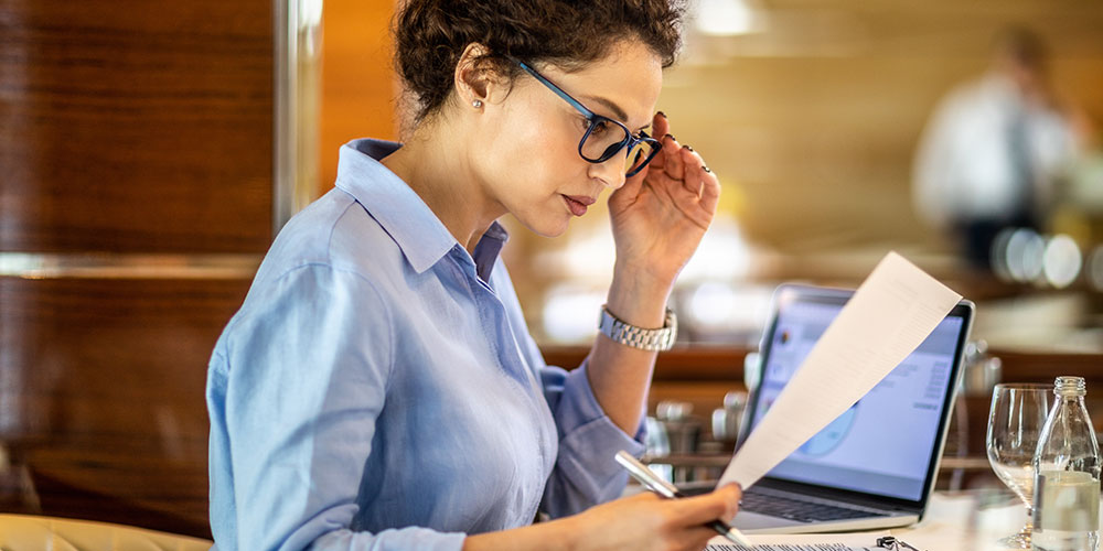 Woman at desk reading paperwork