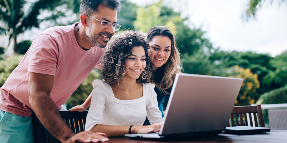 Family looking at a laptop.