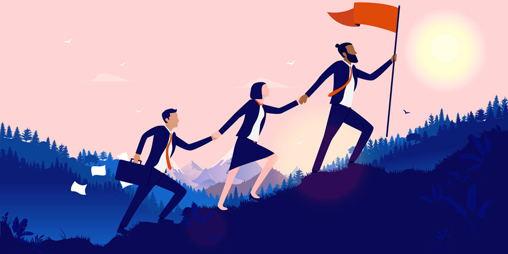 Business partners climbing uphill holding hands.