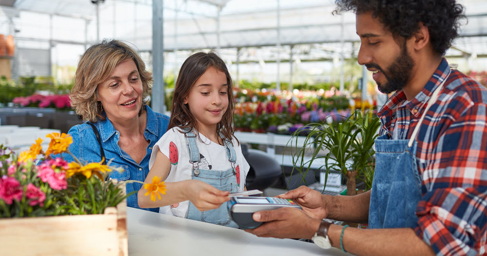 Girl paying for items purchased.