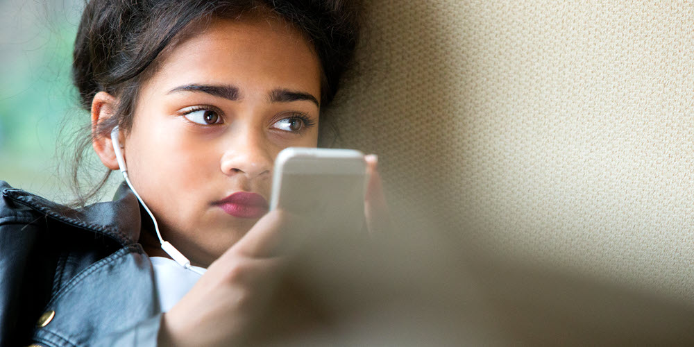 Teen using her phone.