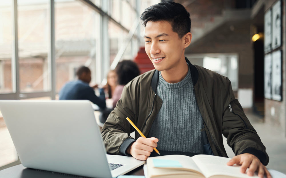 Young adult using laptop.