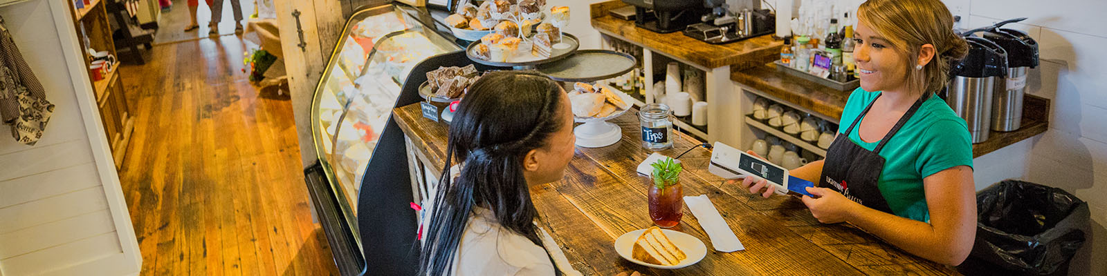Woman purchasing coffee at a shop