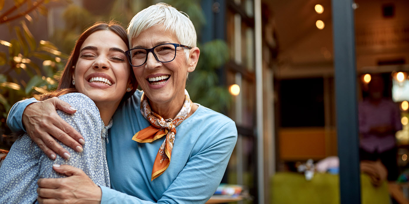 Mother and daughter smiling