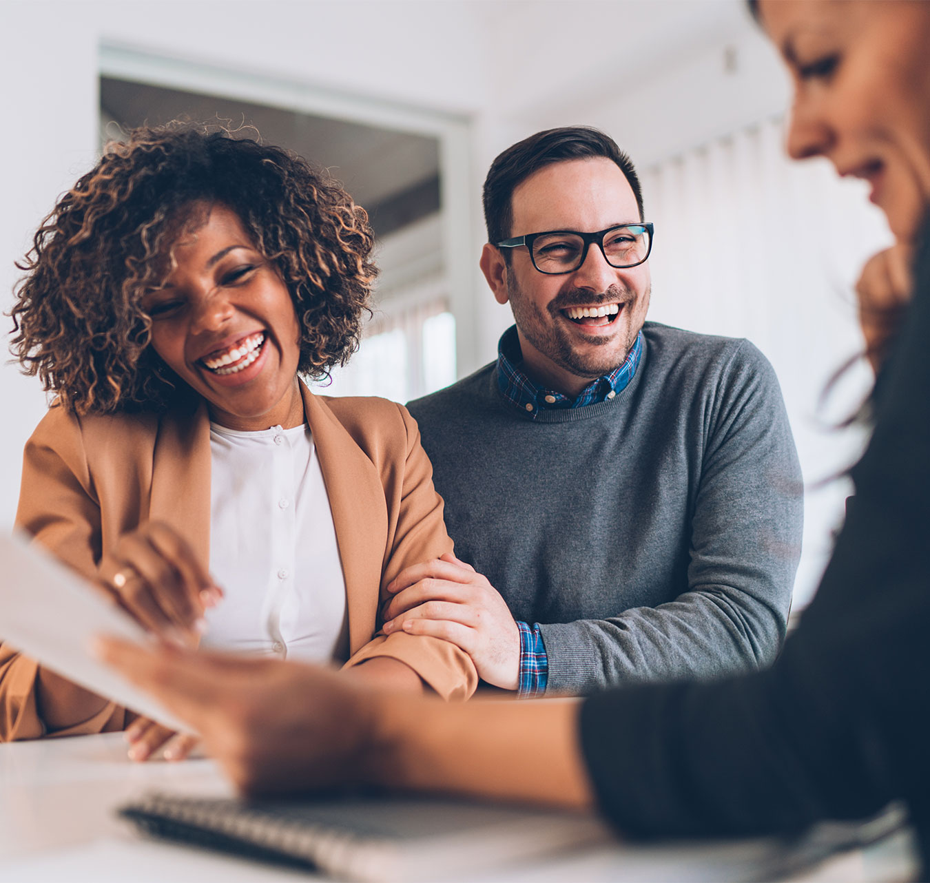 Happy couple having meeting with a professional in a business office.