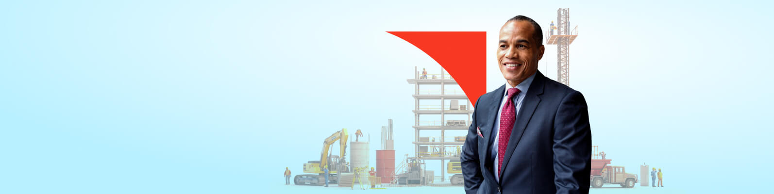 Man smiling with construction behind him