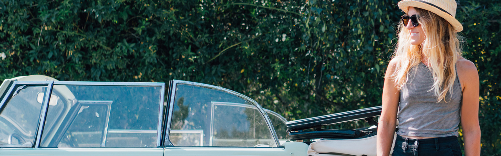 Woman in sunglasses next to car