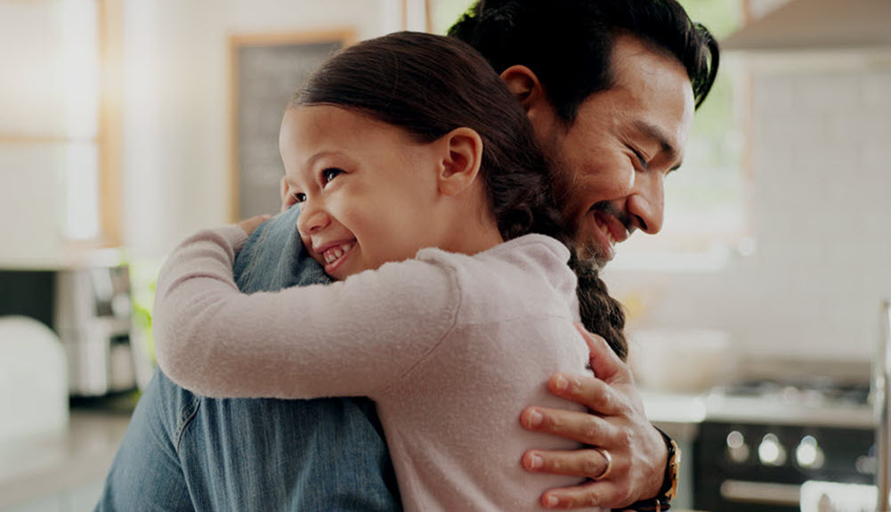 Father embracing daughter in Birmingham