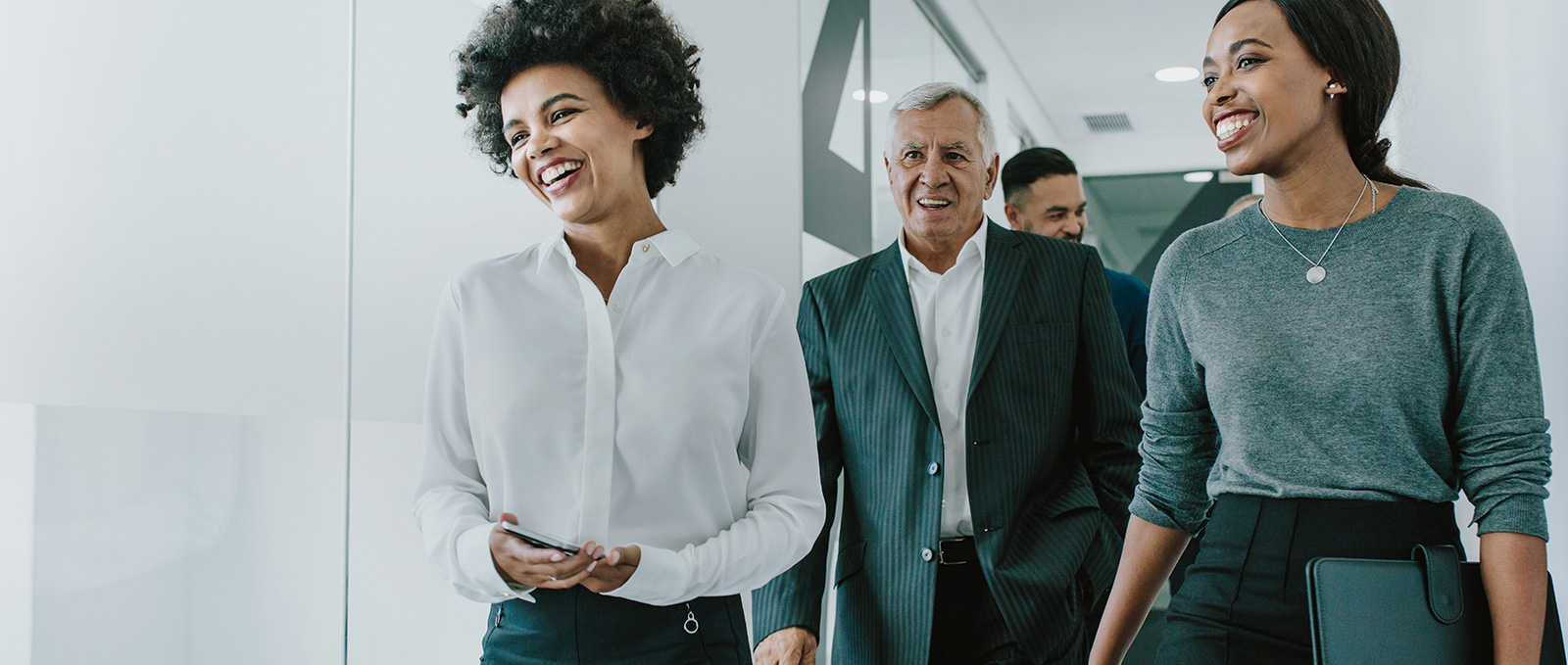 Happy business professionals walking together.