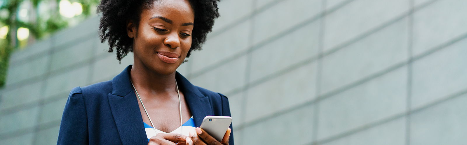 A woman using Small Business Digital Banking on her smartphone