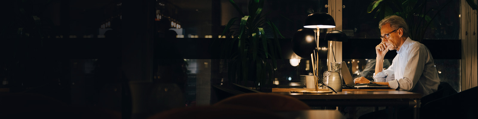 Senior male businessman working late