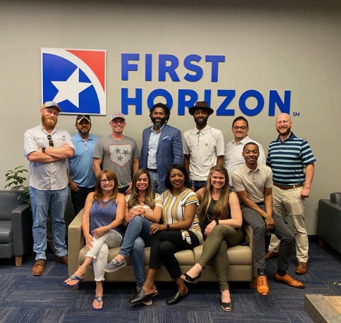 First Horizon team underneath the First Horizon sign.